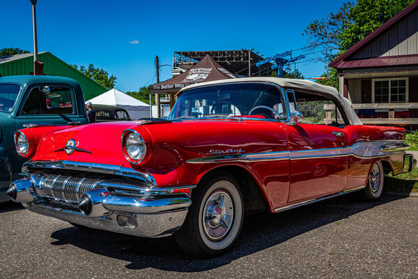 Falcon Heights, MN - June 17, 2022: Low perspective front corner view of a 1957 Pontiac Star Chief Convertible at a local car show.