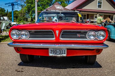 Falcon Heights, MN - June 17, 2022: Low perspective front view of a 1963 Pontiac LeMans Convertible at a local car show.