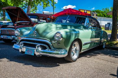 Falcon Heights, MN - June 17, 2022: Low perspective front corner view of a 1948 Oldsmobile 98 Futuramic Convertible at a local car show.