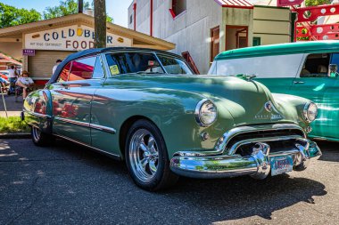 Falcon Heights, MN - June 17, 2022: Low perspective front corner view of a 1948 Oldsmobile 98 Futuramic Convertible at a local car show.