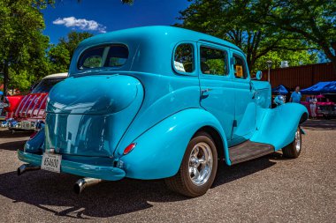 Falcon Heights, MN - June 17, 2022: Low perspective rear corner view of a Customized 1935 Studebaker Dictator Six Sedan at a local car show.