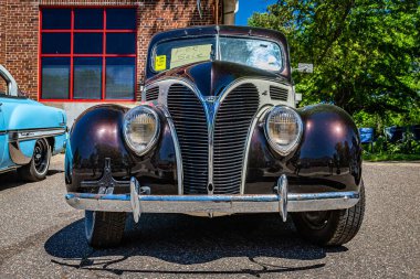 Falcon Heights, MN - June 17, 2022: Low perspective front view of a 1938 Ford V8 Deluxe Coupe  at a local car show.