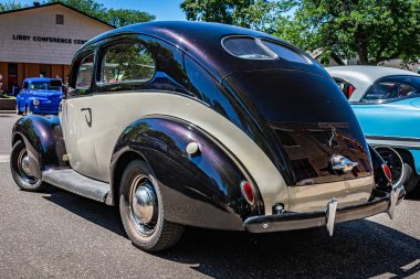 Falcon Heights, MN - June 17, 2022: Low perspective front corner view of a 1938 Ford V8 Deluxe Coupe at a local car show.