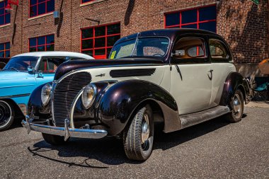 Falcon Heights, MN - June 17, 2022: Low perspective front corner view of a 1938 Ford V8 Deluxe Coupe at a local car show.