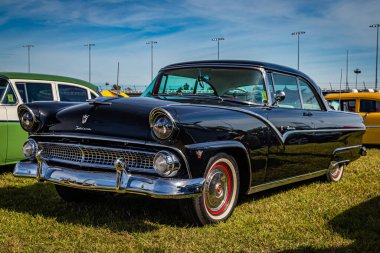 Daytona Beach, FL - November 24, 2018: Low perspective front corner view of a 1955 Ford Fairlane Victoria Hardtop Coupe at a local car show.