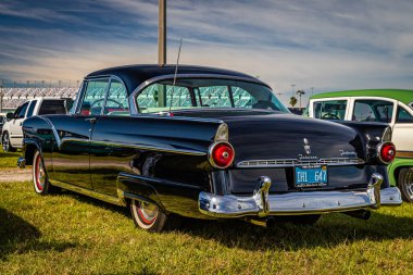 Daytona Beach, FL - November 24, 2018: Low perspective rear corner view of a 1955 Ford Fairlane Victoria Hardtop Coupe at a local car show.