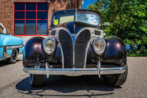 Falcon Heights, MN - June 17, 2022: Low perspective front view of a 1938 Ford V8 Deluxe Coupe  at a local car show.