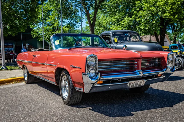 Falcon Heights, MN - June 17, 2022: Low perspective front corner view of a 1964 Pontiac Catalina Convertible at a local car show.