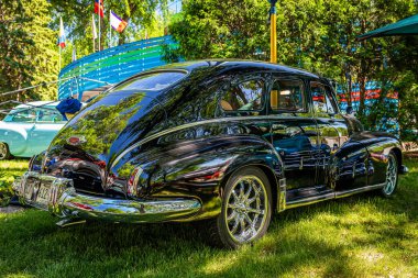 Falcon Heights, MN - June 17, 2022: Low perspective rear corner view of a 1948 Oldsmobile Dynamic Cruiser 78 Sedan at a local car show.