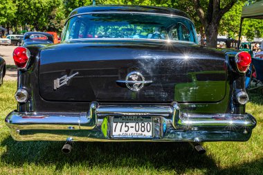 Falcon Heights, MN - June 17, 2022: Low perspective rear view of a 1955 Oldsmobile 88 Holiday Coupe at a local car show.