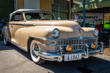 Falcon Heights, MN - June 17, 2022: Low perspective front corner view of a 1947 Chrysler New Yorker Highlander Convertible at a local car show.