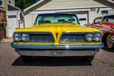 Falcon Heights, MN - June 17, 2022: Low perspective front view of a 1961 Pontiac Bonneville 2 Door Hardtop at a local car show.