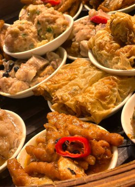 The Hong Kong dim sum, chicken feet, pork ribs, meet ball in bamboo steamer
