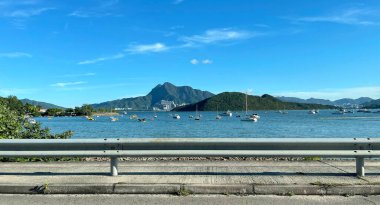 The beautiful photography of mountain, bay, yacht, recreational boats on lake and sky