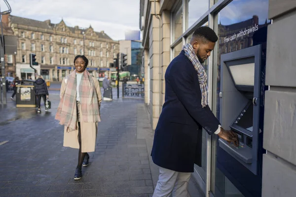 Мужчина Снимает Деньги Банкомата Женщина Проходит Мимо Центре Города — стоковое фото