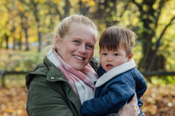 Mid Adult Woman Carrying Her Baby Boy Her Arms While — стоковое фото