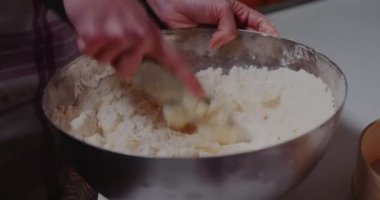 Woman Working in the Kitchen mixing flour and butter in bowl., Baking Croissants and Cookies.