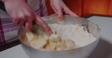 Woman Working in the Kitchen mixing flour and butter in bowl., Baking Croissants and Cookies.