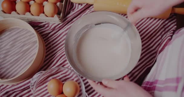 Woman kneading dough for bread. Manufacturing process of sweet cake. — Video