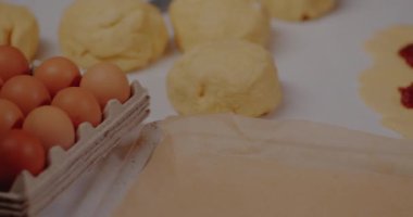 Woman puts Fruit Jam on Dough making Croissants Baking Pastries