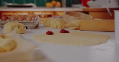 Woman puts Fruit Jam on Dough making Croissants Baking Pastries