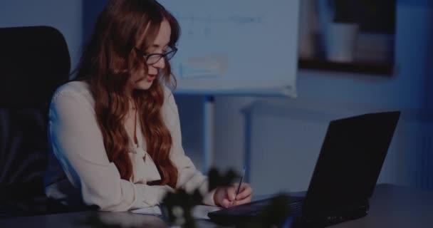 Jeune femme d'affaires travaillant tard dans le bureau — Video