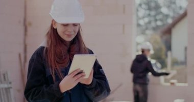 Dijital tablet kullanan gülümseyen genç bayan mimar