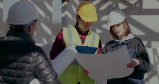 Architect discussing blueprint with engineer and contractor — Video
