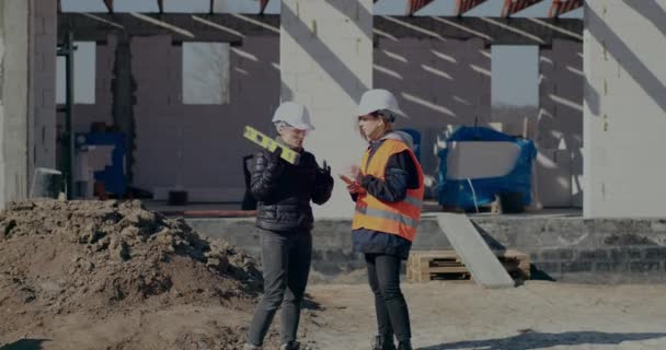 Genç bayan mühendis inşaat alanında tartışıyor. — Stok video