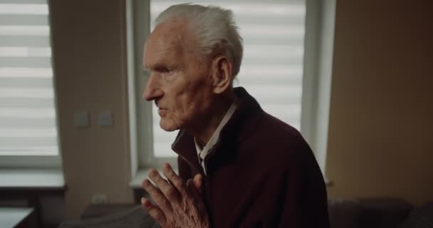 Elderly Senior Man Praying at Home — Stockvideo