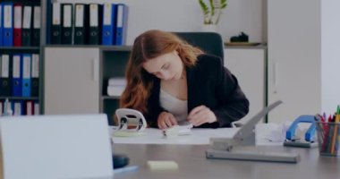medium shot of Tensed Businesswoman Working on Laptop in Office. Stressed Businesswoman In Office working on a project, writing e-mail.