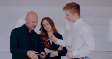Group of business people discussing financial report, businessman, businesswoman and manager talking on a project, brainstorming at meeting, shaking hands. Signing documents.
