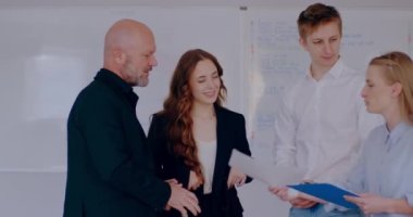 Group of business people discussing in office or financial report, businessman, businesswoman and manager talking on a project, brainstorming at meeting, shaking hands. Signing documents.