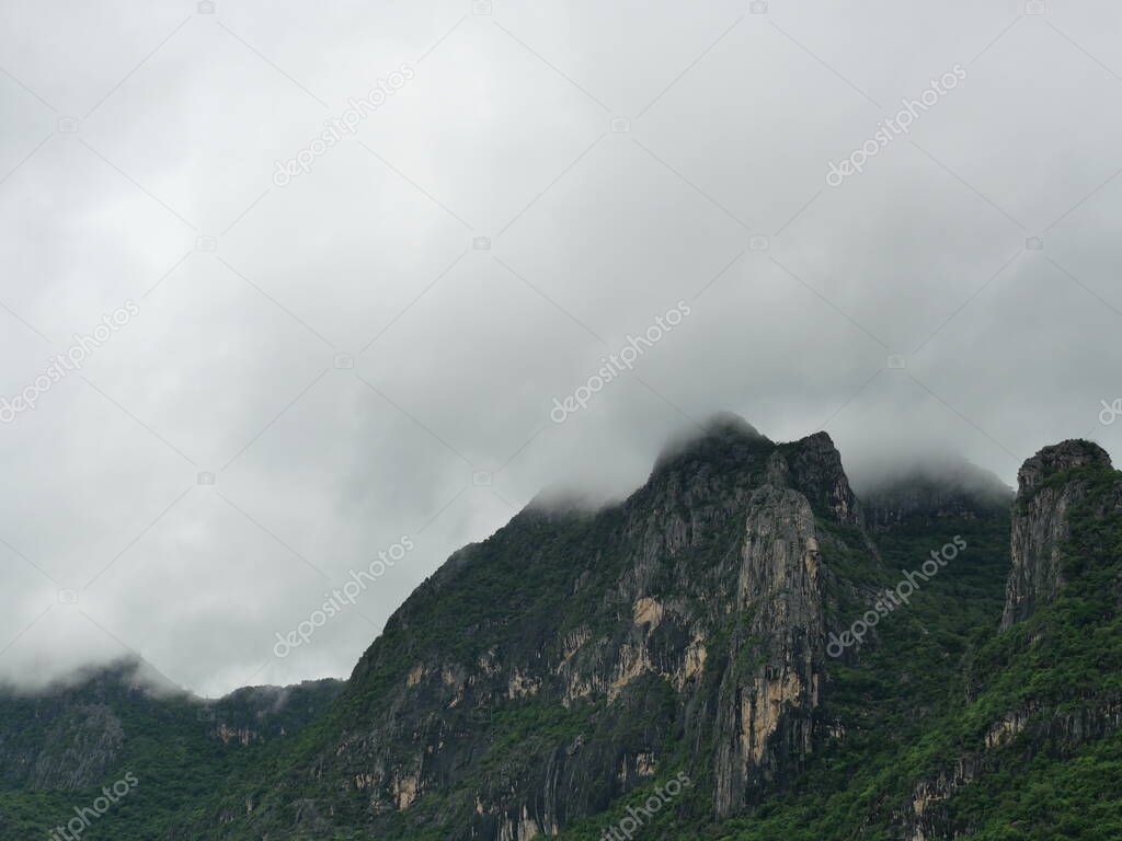 Cloud and fog cover limestone mountain in the rainy season, Green forest and rock at Khao Sam Roi Yot National Park, Thailand