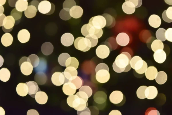 Bokeh from indoor lighting, Colorful light circles spread on purple with yellow with pink and orange color on black background for the celebration of the holiday season