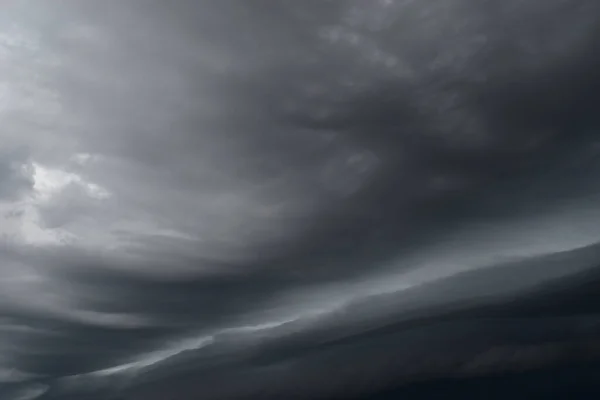 Arcus cloud rolling in the storm, Cumulonimbus cloud formations on tropical sky , Nimbus moving , Abstract background from natural phenomenon with black and gray clouds hunk