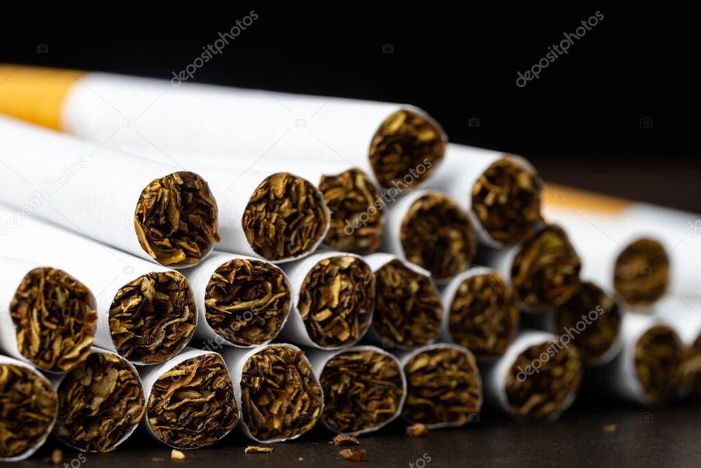 Many cigarettes stacked together. Drugs are harmful to the respiratory system.