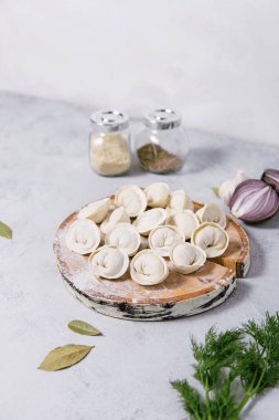 Traditional Russian food dumplings on a cutting board, ravioli, pelmeni. 