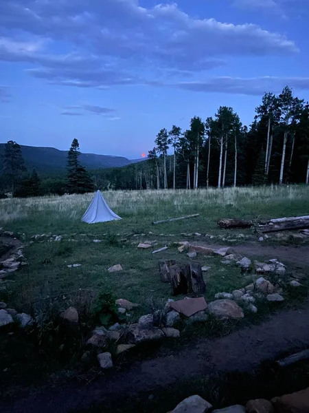 13 Temmuz 2020 'den kalma bir Buck Moon. Çimlerin üzerinde küçük bir çadır olan bir çayırın tepesinden. 2022 Yaz sezonunda Philmont Scout Çiftliğinde çekildi.