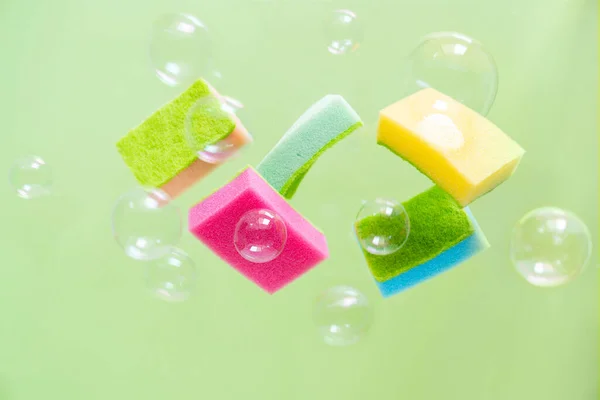 Cleaning Concept Levitation Dishwashing Sponges Green Background Copy Space — стоковое фото