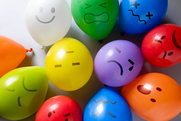 Mental health concept - selection of emojis on colorful balloons for different mental states. High quality photo