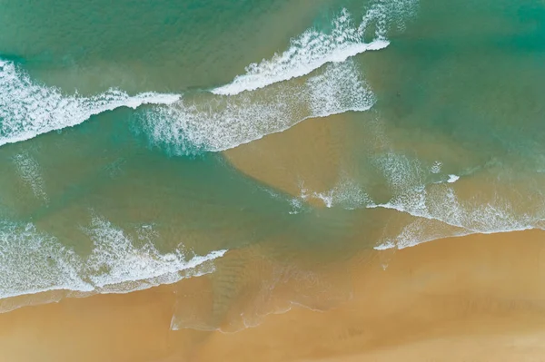 Top View of the Sea texture waves Foaming and Splashing on beach Beautiful wave sea surface background.