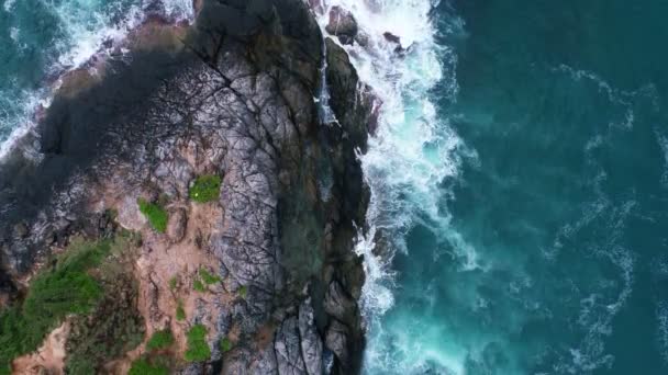 해변의 바위들에 거품을 일으키는 공중에서 바라본 환상적 해안의 놀라운 — 비디오