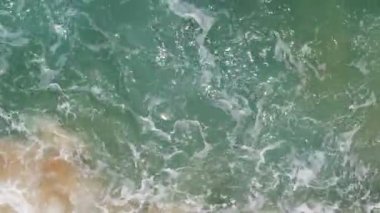 Top View of the sea surface Waves crashing Foaming and Splashing in the Ocean. Sunny Day summer background High quality footage. Phuket sea Thailand