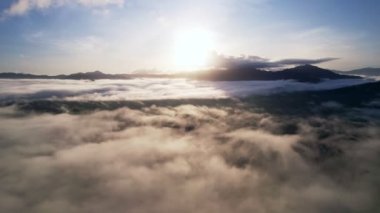 İnsansız hava aracı görüntüsü sis veya sis denizi üzerinde uçuyor. Yüksek açı Dinamik hava görüntüsü. Doğanın muhteşem manzarası.