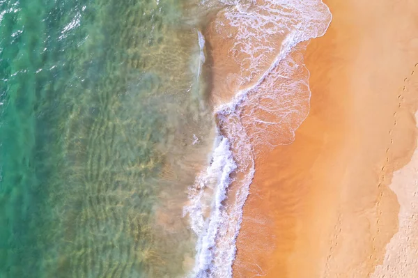 Sea background Aerial view Top down sea waves crashing on sandy beach beautiful sand sea surface in Phuket thailand