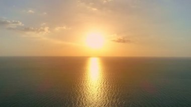 Tropikal deniz günbatımında ya da gündoğumunda 4K deniz videosunun üzerinde güneş ufka dokunur, kızıl gökyüzü altın saatinde inanılmaz deniz manzarası, okyanus günbatımları