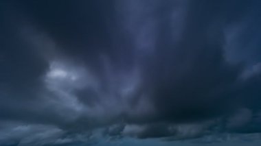 Timelapse amazing Dark sky cloud background Epic storm tropical sunset dark cloud stormy.Digital cinema composition background Black Clouds fast moving away.Global warming motion black sky dark cloud