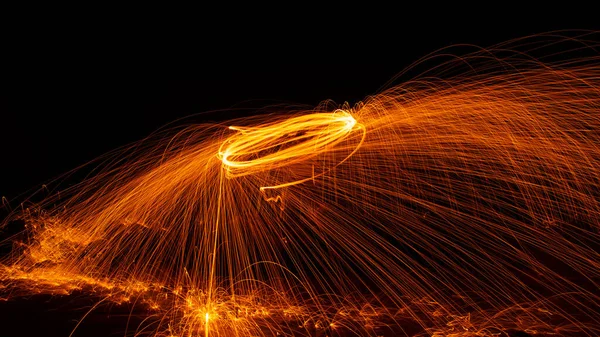Swing fire Swirl steel wool light photography with reflex in the water long exposure speed motion style ,Beautiful line of fire