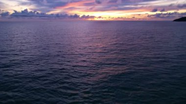 Dark sea water surface, Dynamic shot Aerial view of dark sea surface at Phuket Thailand,Beautiful Tropical sea waves at sunset or sunrise sky. Amazing nature and travel background.High quality footage